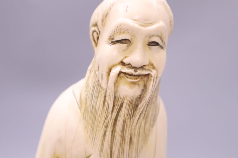 A Chinese simulated ivory figure of an elder, height 37cm